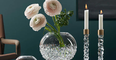 Orrefors Carat Collection featuring the Globe Vases, Candlesticks and Votive Holder.