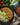 Moroccan lentil stew with rice and avocado on a plate, next to a package of mina AddisMoroccan Lentil Stew.
