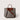 A structured gray felt tote bag with brown leather handles, a brown leather top panel, and a brown shoulder strap, shown on a light beige background.