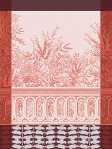 A rectangular tea towel featuring a terracotta red and pale pink toile-style botanical pattern with an arched window motif and decorative border.