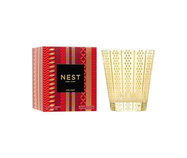 Nest New York Classic Holiday Candle and Package. Candle is in glass container with gold etched design. Package is red and gold with patterned stripes.