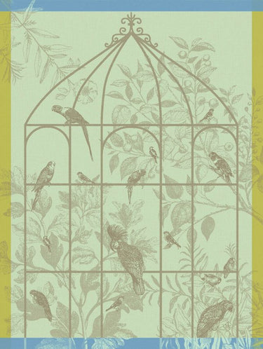 Sonate Tea Towel Collection Shown in Green colorway. Towel features several exotic birds sitting on an outline of a large aviary. The background is vegetation with leaves, flowers and fruit.