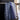 Patterned towel draped over a chair with a blurred indoor background