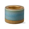 Ceramic container with gradient color design on a white background