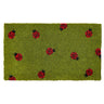 Green rug with red and black ladybug pattern on a white background