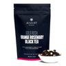 August Gold Rush Orange Rosemary Black Tea package with tea leaves in a bowl on a white background