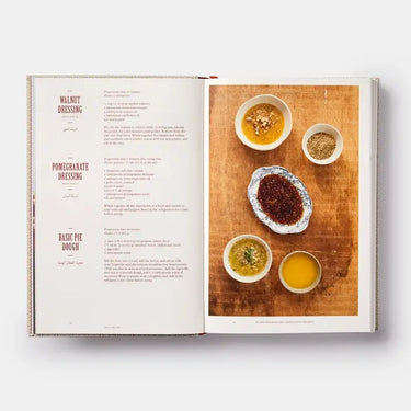 Open cookbook showing a page with a recipe and images of ingredients on a wooden board.
