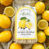 Packaged lemon pepper linguine with lemons on a textured surface