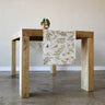 Rustic wood table featuring the table runner with leaves and birds. 