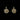 Pair of gold earrings with a black background