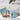 Two illustrations of sailboats on a gray surface with paintbrushes and paint tubes.