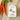 Packaged carrot fettuccine with a Valente Market label next to fresh carrots on a textured surface.