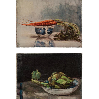 Two canvas wall art pieces depicting vegetable still life. One features carrots, one features artichokes.