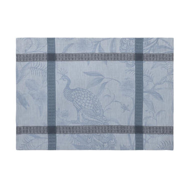 Decorative placemat with peacock design on a light blue background
