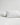 Two bed pillows with white percale pillow cases, one is slightly upright lying on top of the other.