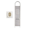 Metal garlic grater with a close-up inset showing the teeth on a white background. Photo credit, Harold Import Company