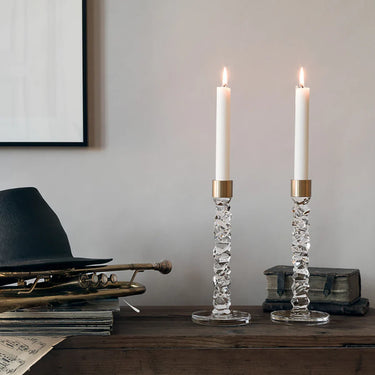 Orrefors Carat Brass Candlestick pair pictured with lit candles