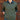 Person wearing a green sweater over a denim shirt with a wooden door background