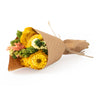 Bouquet of flowers wrapped in brown paper on a white background