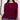 Woman wearing a burgundy sweater with button details against a white wall.