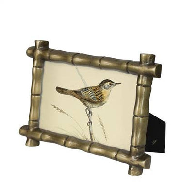 Decorative wall art with a bird illustration inside a bamboo frame on a white background