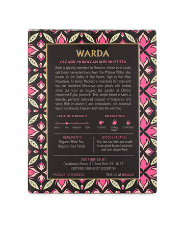 Warda organic Moroccan rose white tea packaging with decorative patterns on a black background