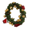 Decorative wreath with gold balls and red gemstones on a white background