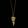 Gold fern leaf necklace on a black background