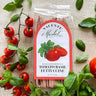 Valentine Market pasta package with fresh tomatoes and basil on a textured surface