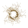 Decorative napkin ring with white berries and gold branches on a white background