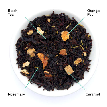 Tea blend with black tea, orange peel, rosemary, and caramel on a white background