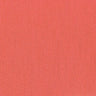 Close-up of a coral-colored cloth napkin showcasing its texture and solid color.