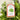 Packaged spinach fettuccine with a Valente Market label surrounded by fresh spinach leaves.