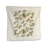 Cream, soft textured kitchen towel with pine branches, pine cones, and owls. 