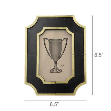A framed wall art print featuring a silver trophy cup illustration on a beige background, surrounded by a black and gold frame. The image includes dimension lines indicating a height of 8.