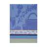 A blue kitchen towel with a floral pattern and a woven label, featuring Indian motifs such as tapenade, garlic, and tomatoes.
